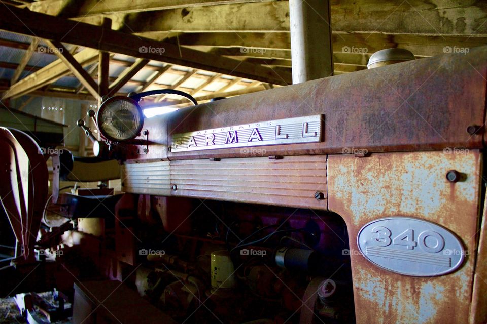 Antique International Farmall tractor in an old barn