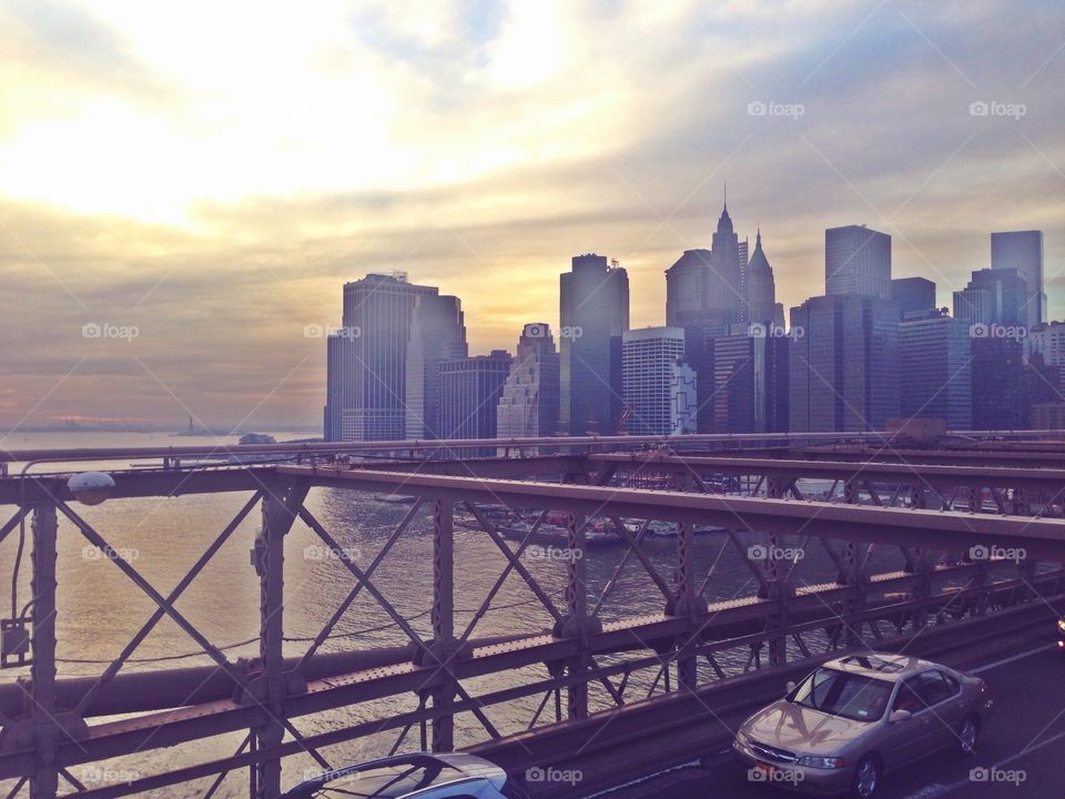 Manhatten from Brooklyn Bridge by sunset
