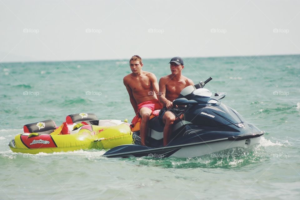 Two guys at a water bike 