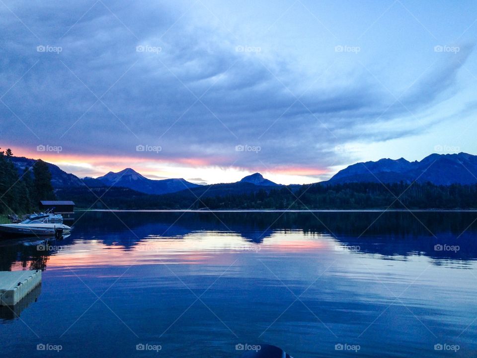 Scenic view of lake against cloudy sky