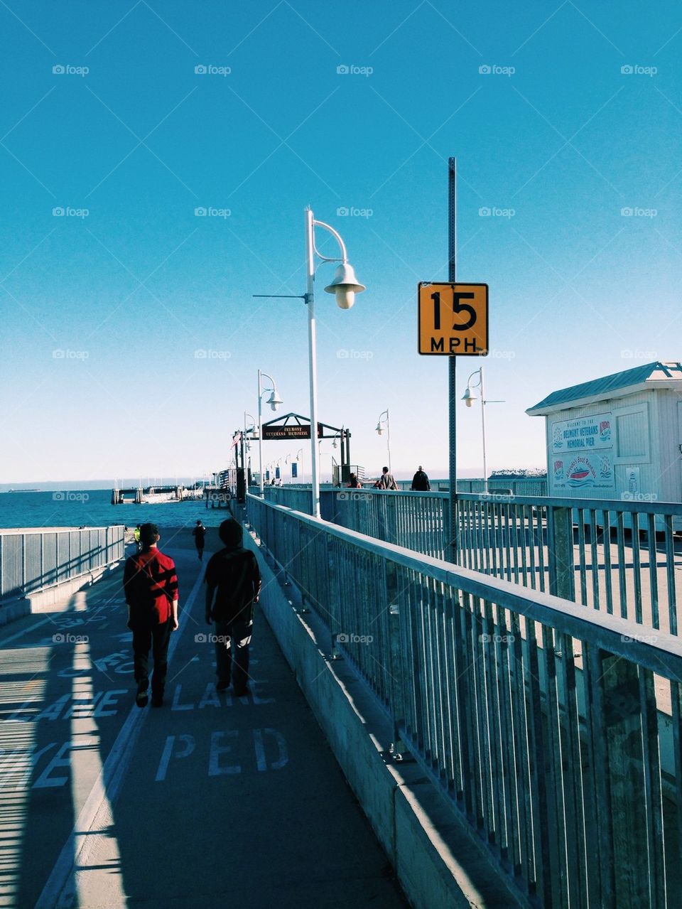 Friends walking by pier