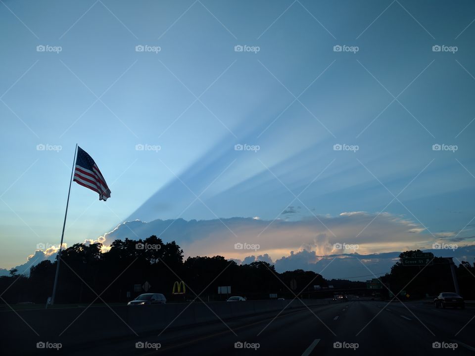 American flag with cloud shadow in the back