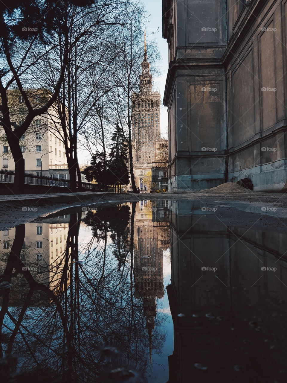 Palace of Culture and Science reflection in a puddle.