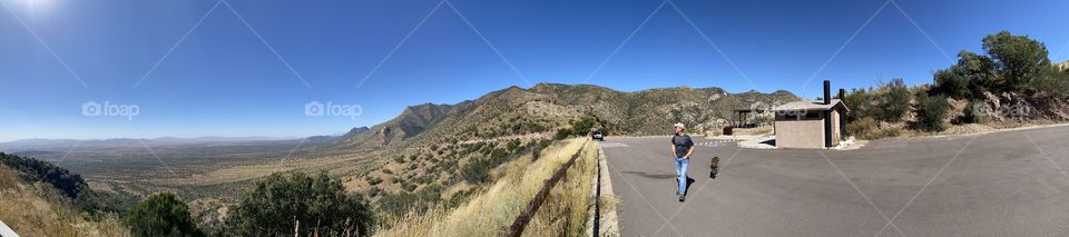 Man and his faithful companion admire the view from Southeastern Arizona