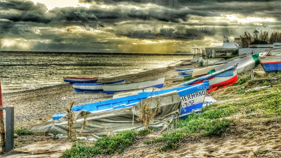 Fishing Boats in Marbella . Fishing Boats on the beach with Gibraltar in the background 