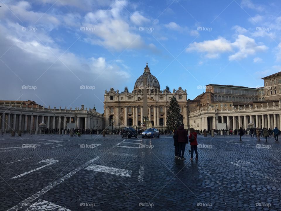 Blue skies over St. Peter’s Basilica in Vatican City on New Year’s Day, 2018. Wet pavement and Christmas trees still standing. 