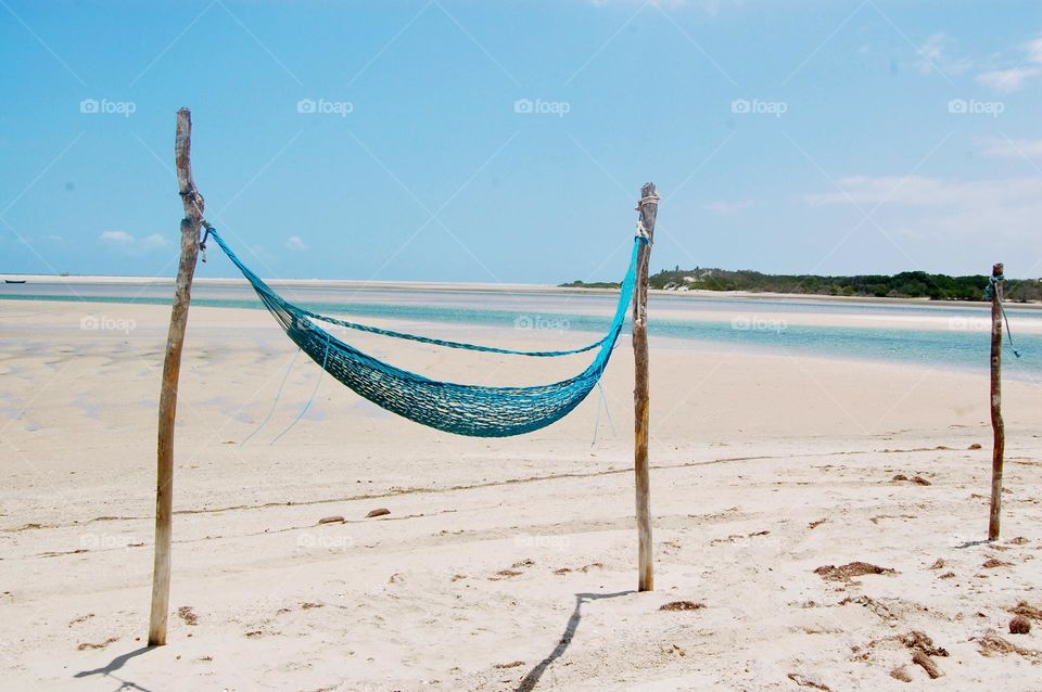 Blue hammock in desert beach. Seaside 