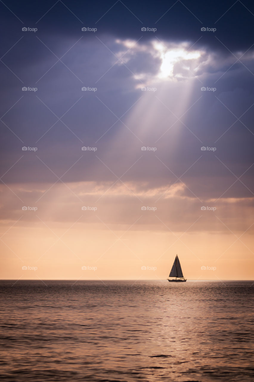 Sailboat on sun lit sea