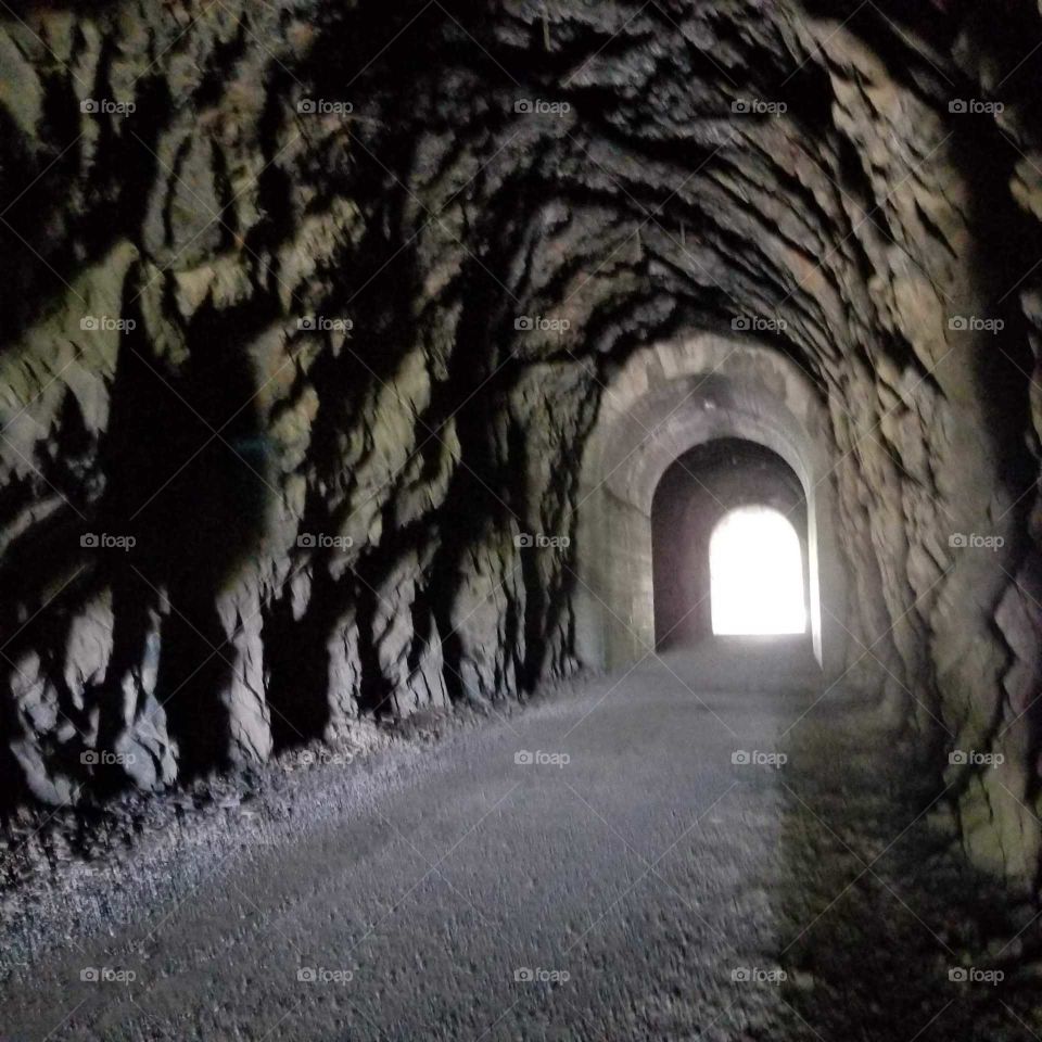 inside view of an old railroad tunnel and opening
