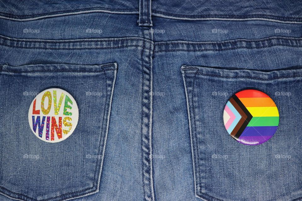 Pride pins on jeans