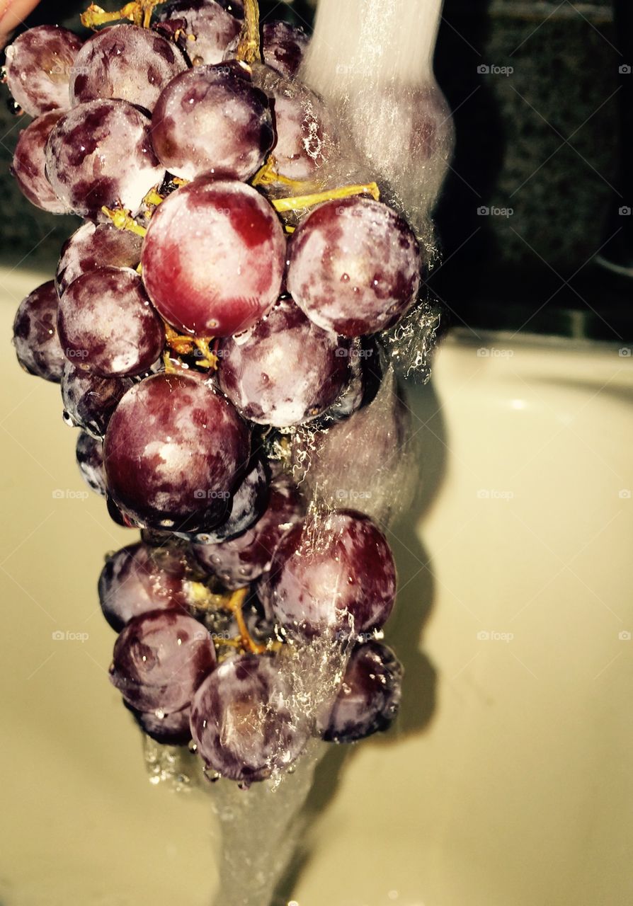 Water running over grapes