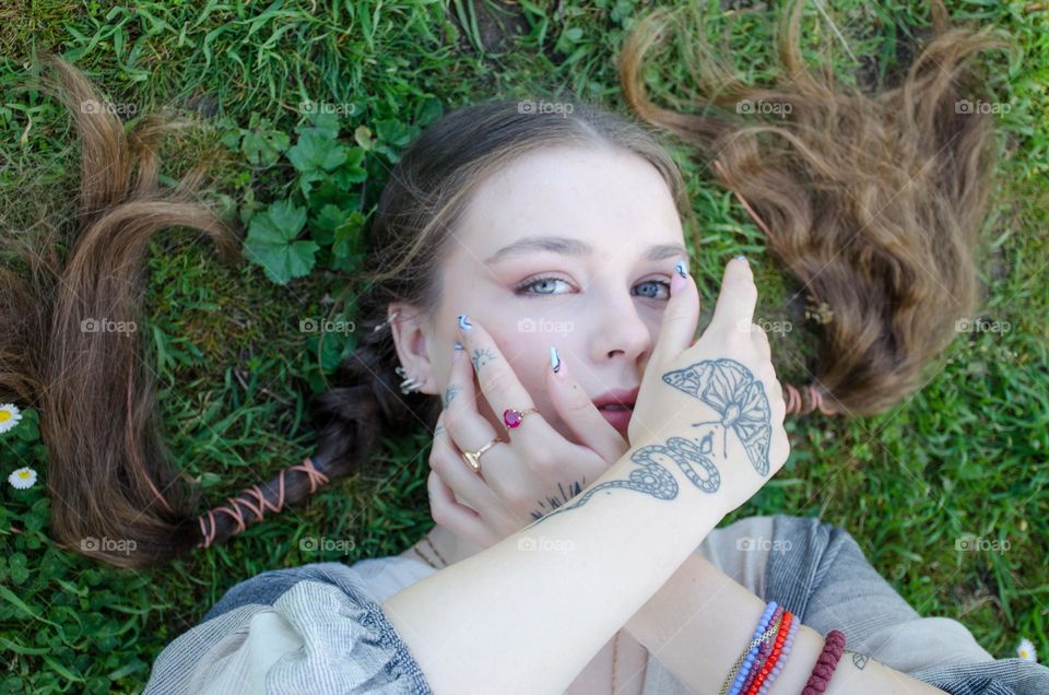 Portrait of Young Girl on Background of Daisies