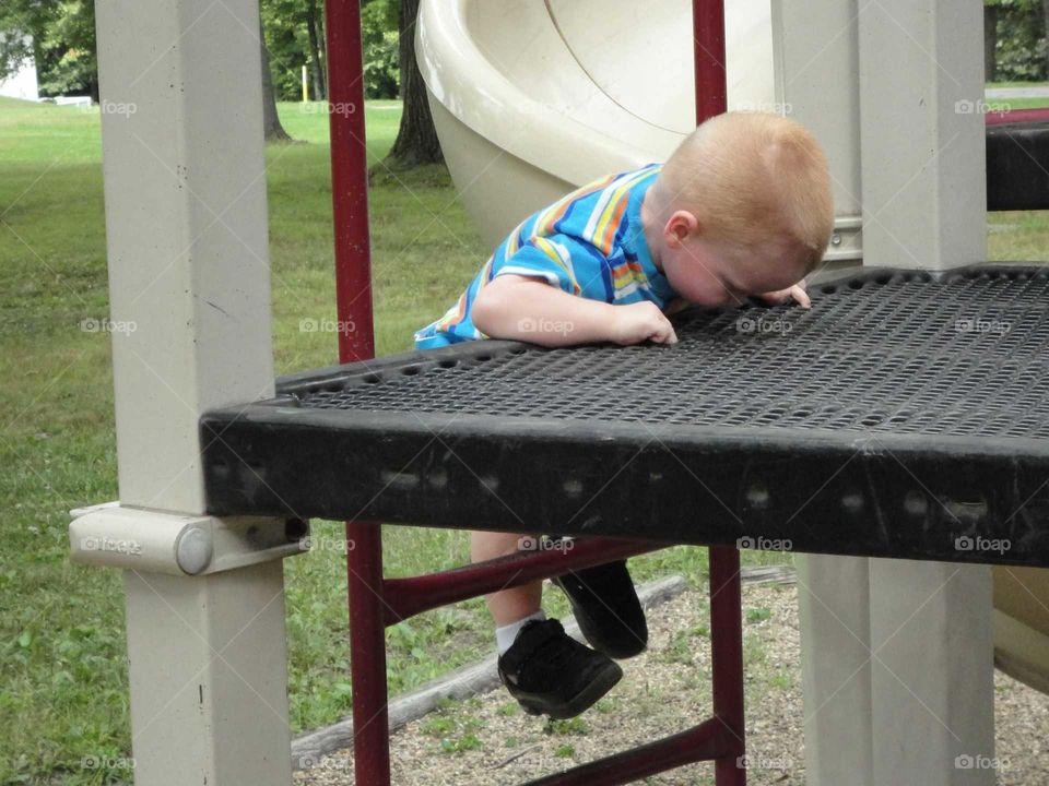 boy climbing playground