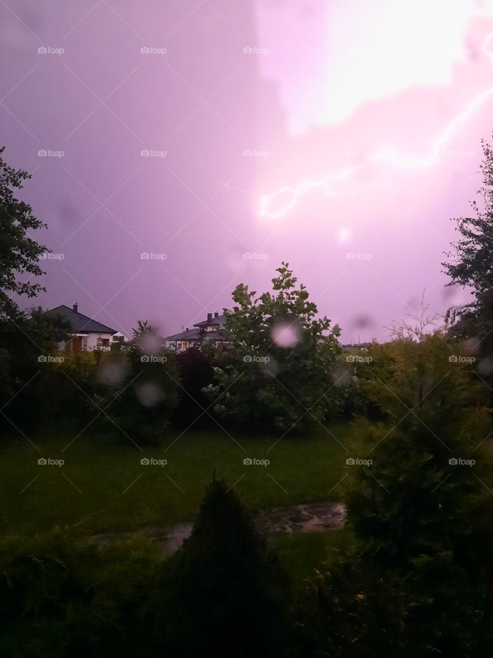 summer storm with lightnings  observed through widow