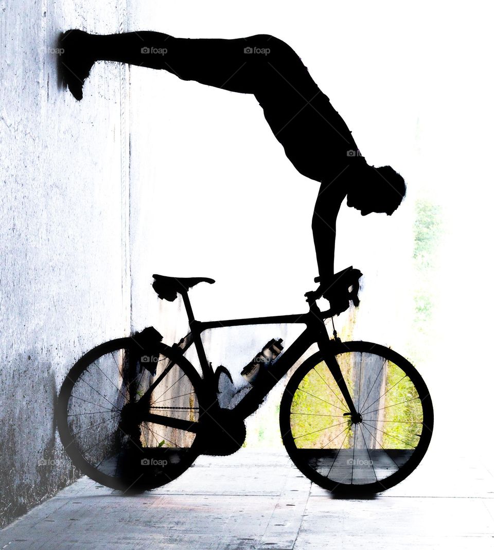 A bike ,up side down. thats weird . Against the sun . into a tunnel . Black and White