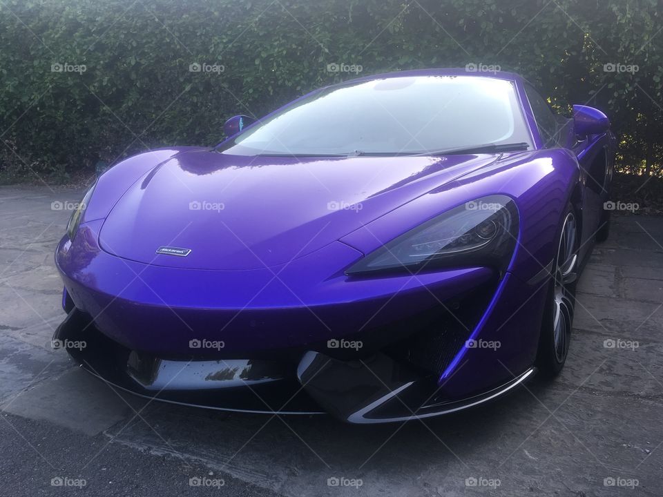 Purple McLaren 570S parked at the spa of the 5 star Coworth Park Hotel in Berkshire, where Princes William and Harry stayed the night before the Royal Wedding in Windsor. Spring.