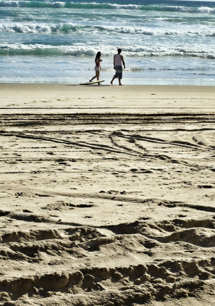 beach scene with two people walking summer vacation