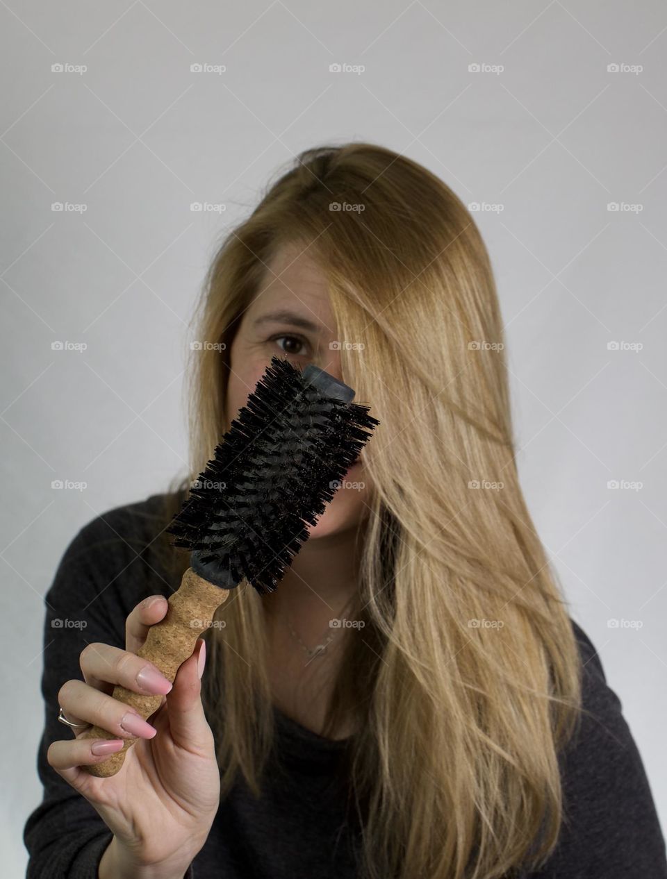 Woman showing up soft, shiny hair with a smile