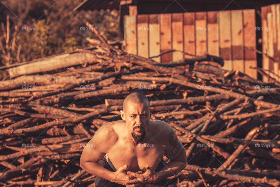 Man do some exercise at outdoor on countryside background.