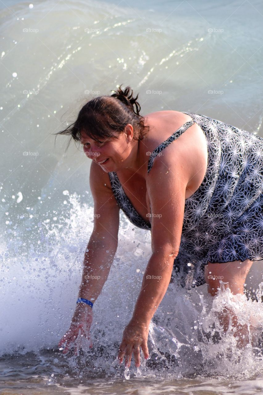 Woman enjoying in splashing wave