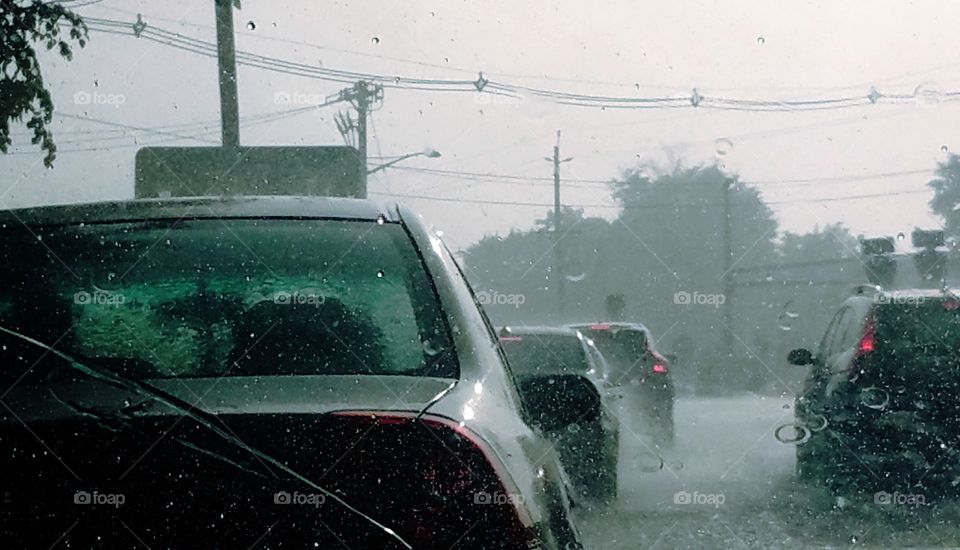 A commute through traffic as the rains pour.