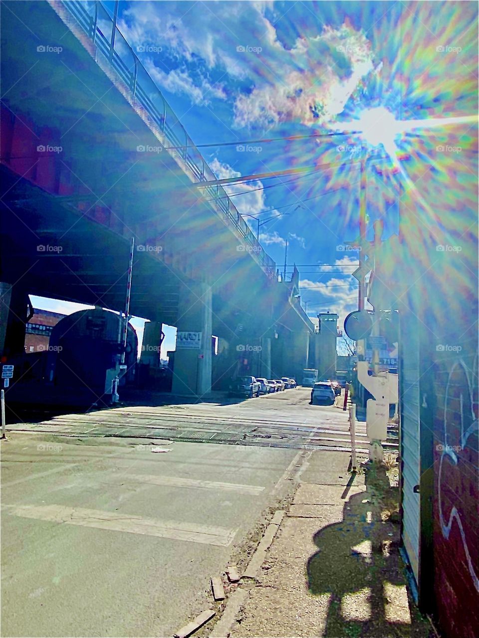 A beautiful refraction radiating out from the sun was created by the light on this photograph taken just today on January 27, 2022 while walking thru the parking lot beneath the Pulaski Bridge in LIC, Queens to get to our boat. Hypnotic Productions