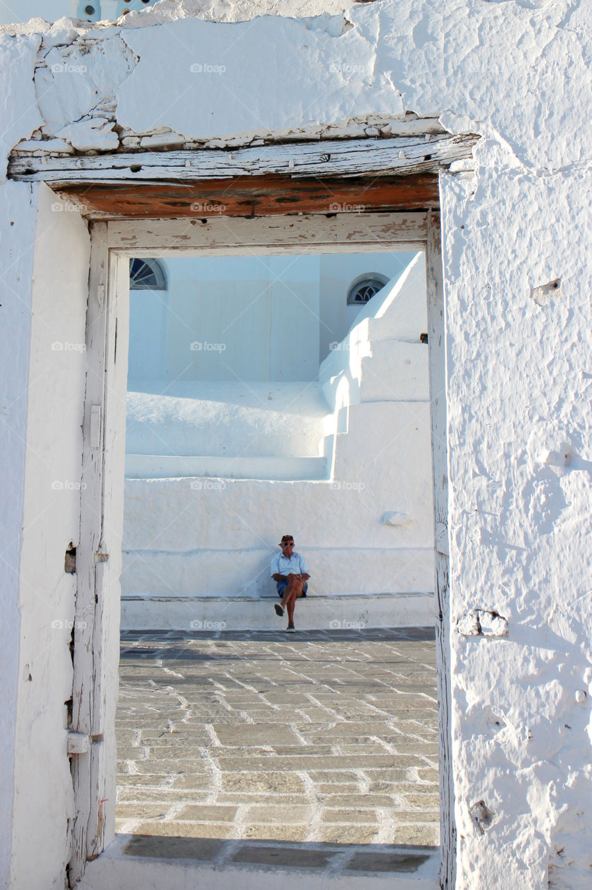 A frame of a man sitting in Ios Island