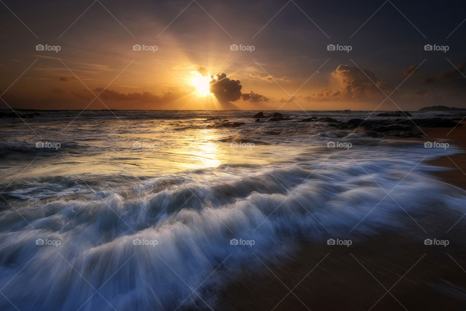 Beach and waves at sunset