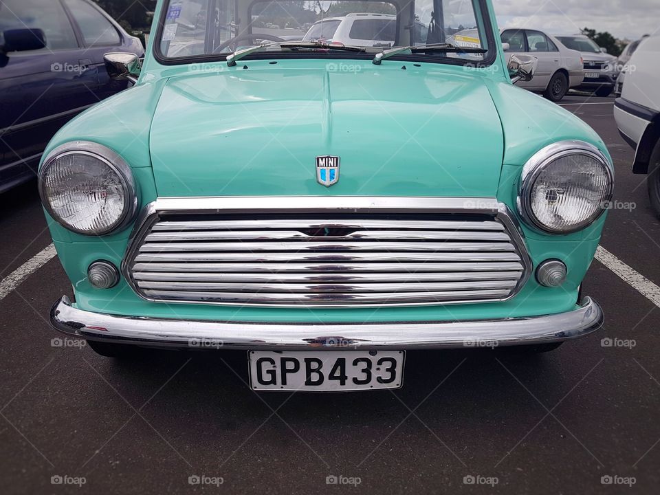 Classic Austin Mini turquoise colour in car park vintage old car