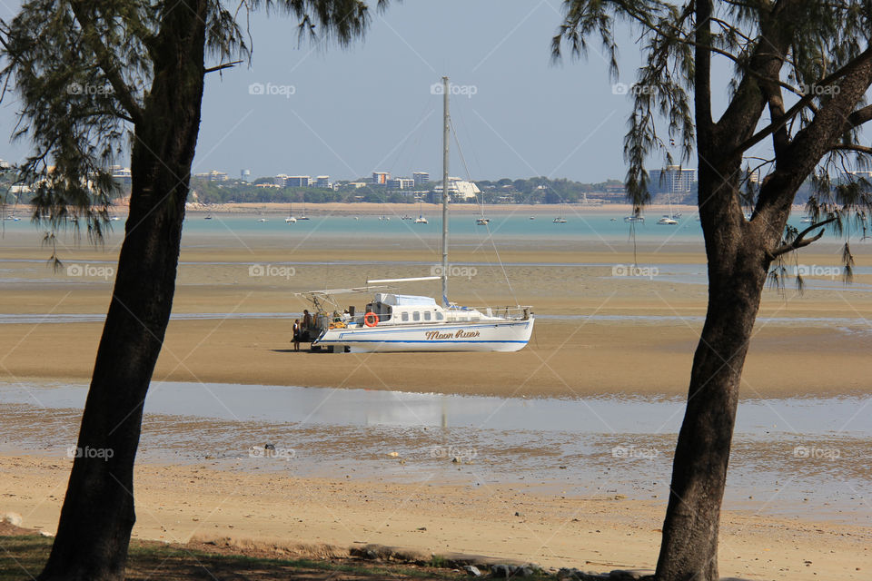 Catamaran beached during low tide in Darwin.