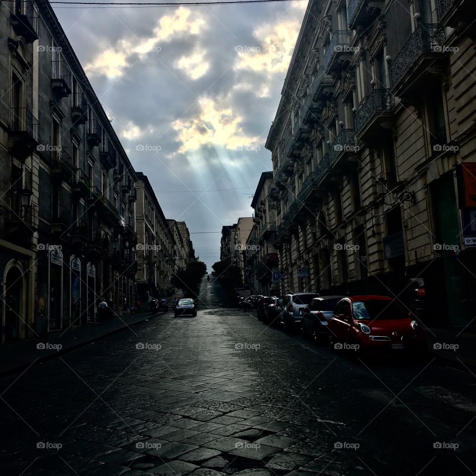 The sunlight peaked through the clouds as I walked along the streets of Catania, Italy. 