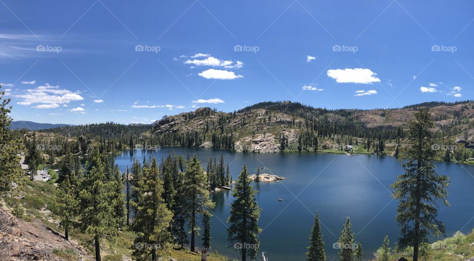 Beautiful view of lake in California with trees and mountains in background