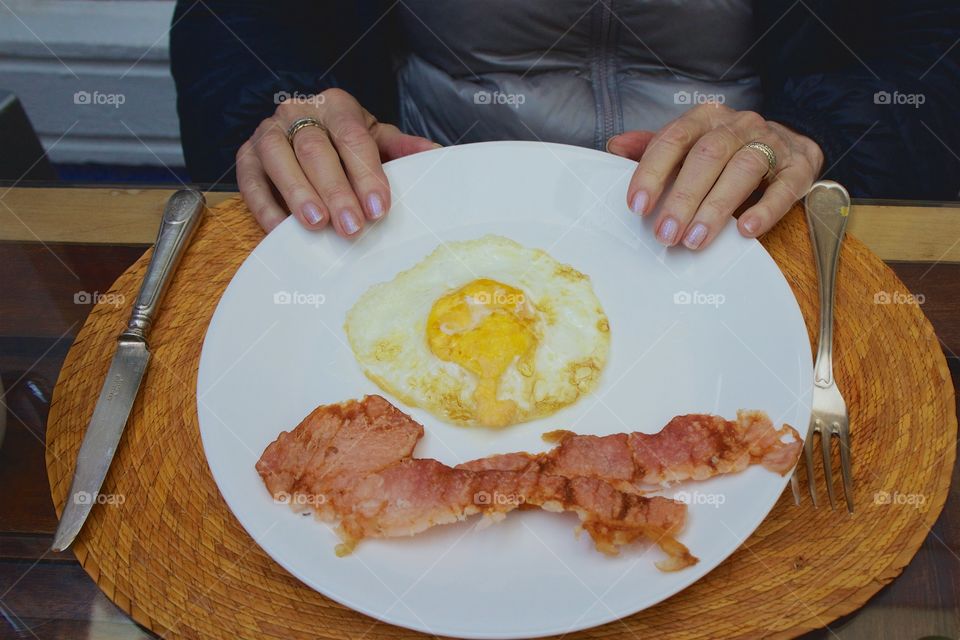 Cooked egg and meat on white plate