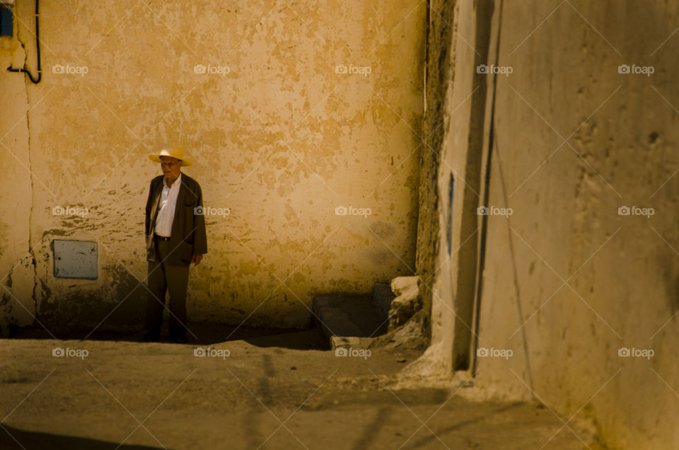 Old man wandering trough the street