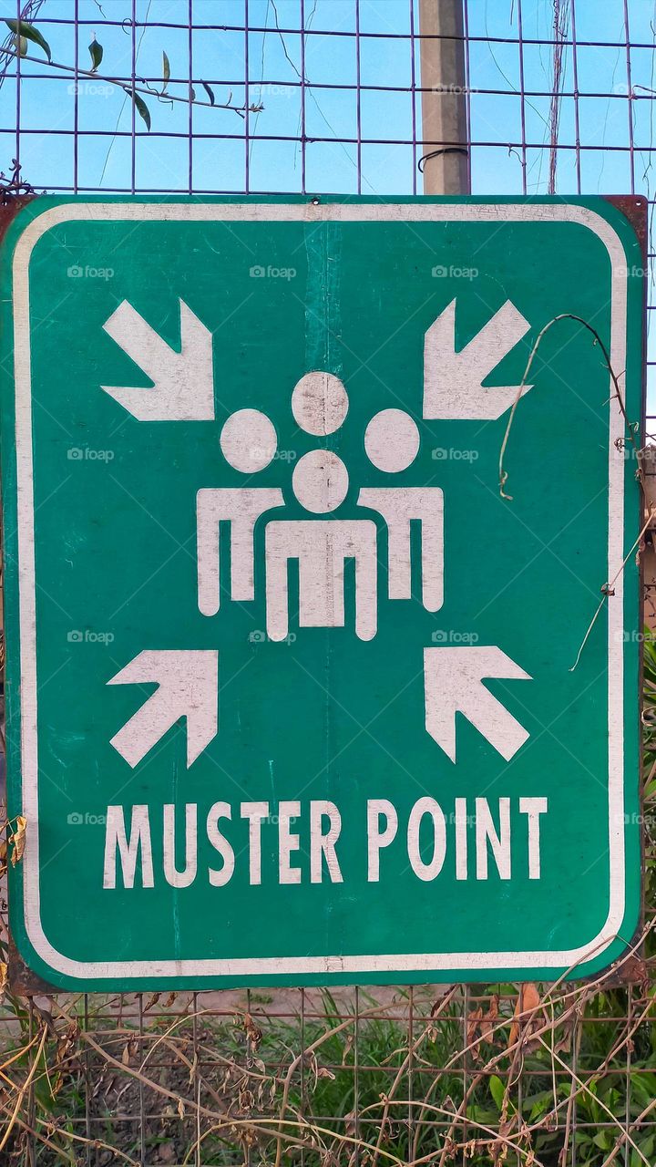 Sign post muster point for people gather together when emergency situation happen, like fire and earthquake.