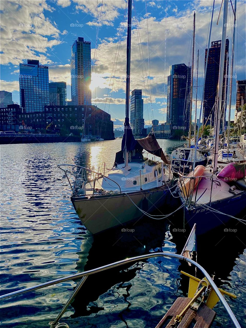 This is “Newtown Creek” in LIC, Queens with its idyllic looking boats at sunset time just before twilight. The still intense sunlight bathes everything in its golden glow and the ocean reflects it back for a special allure. 2023. Hypnotic Productions