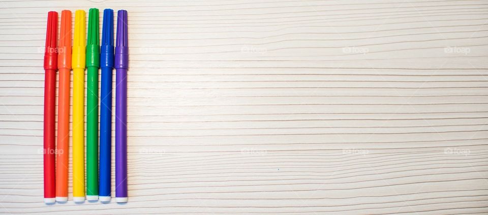 Multicolored Markers On A Wooden Background