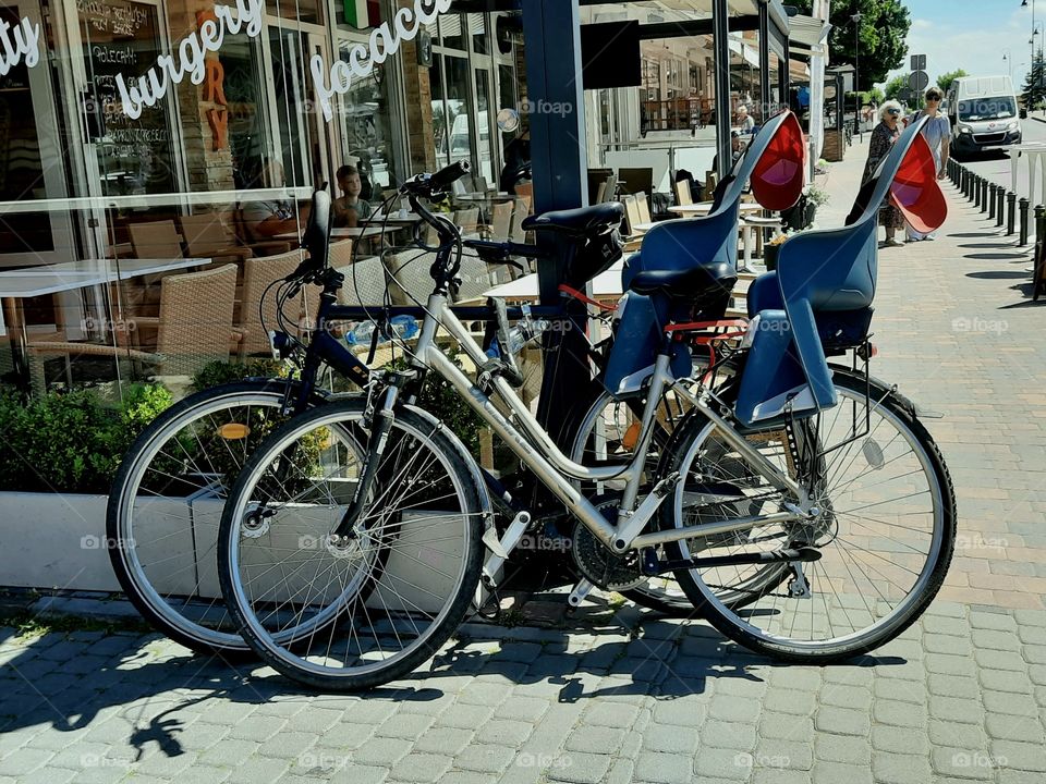 bicycles with kids chairs on the street