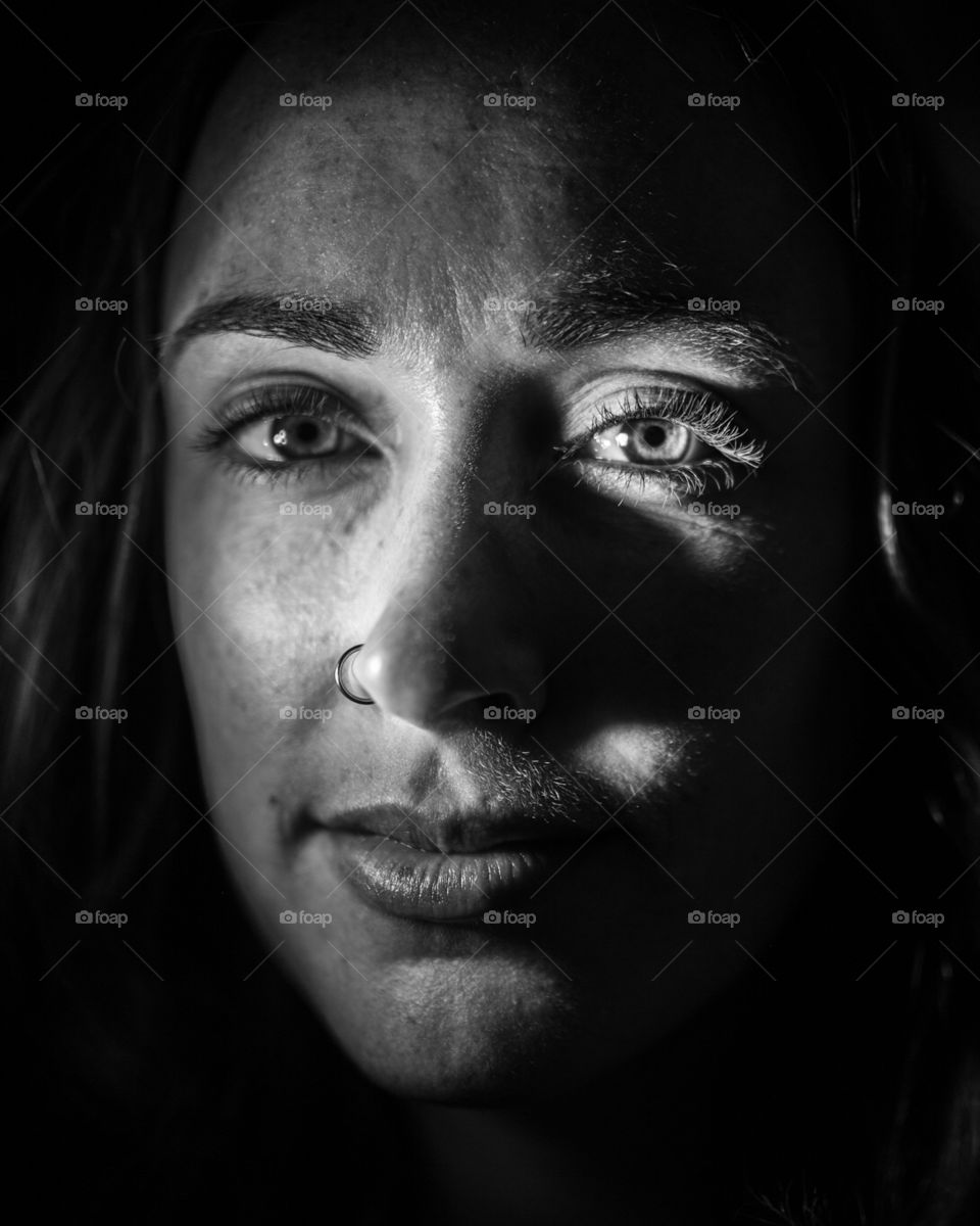 Moody image of my roommate in a creepy closet. The lighting is harsh, and features the Rembrandt triangle. 