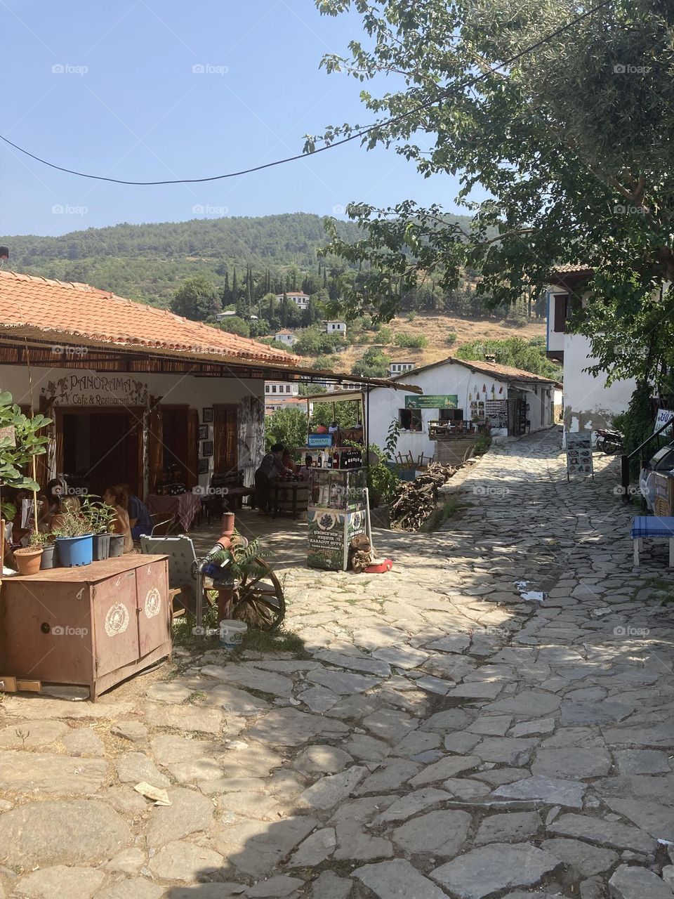 Greek village in Turkey. Blue sky and tall palm trees. Sunsets and sunny days. Summertime in Kusadasi. Vacation travel in Turkey . Summer view. Sunny day during vacation 