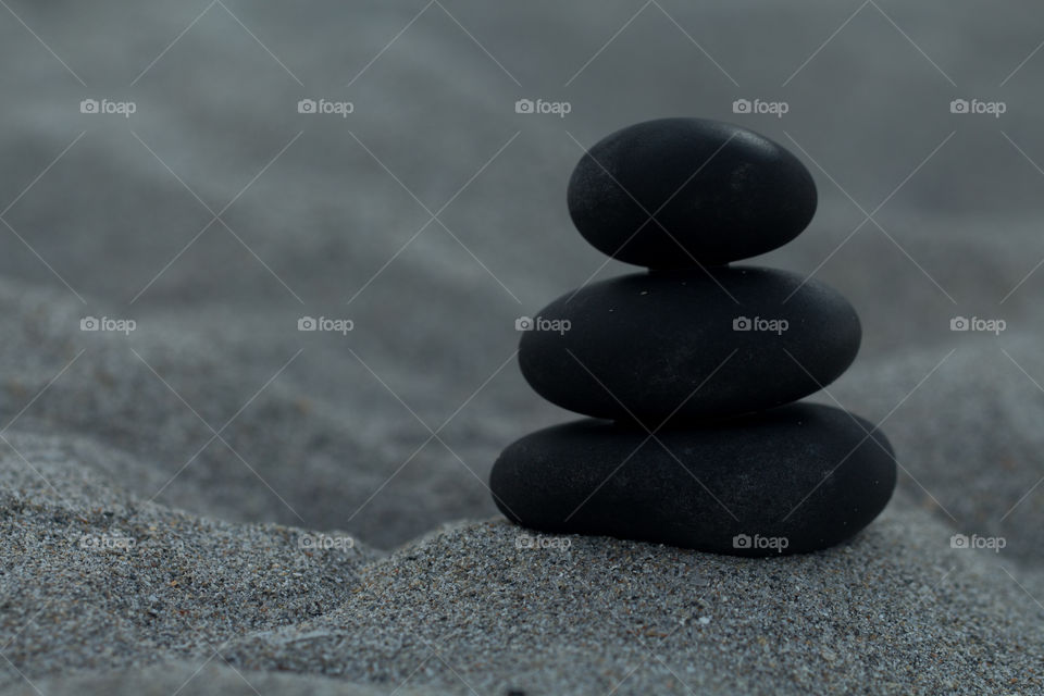 Stack of pebbles on sand