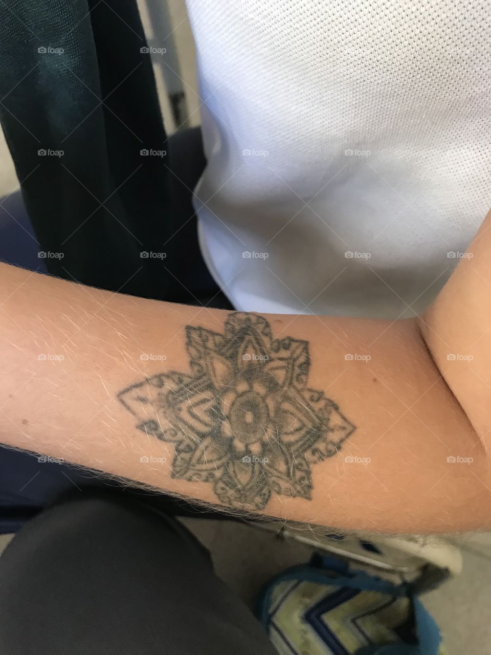 Tatuaje de mandala en brazo de mujer joven 
