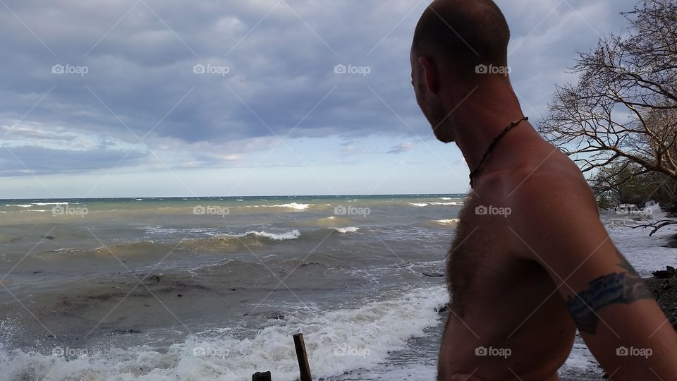 man looking out at ocean