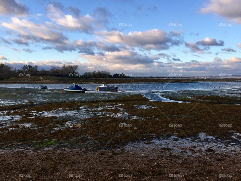 Sea at low tide and boats 