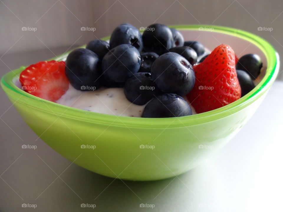 Healthy fruits breakfast full of vitamins with strawberry, berries and yogurt