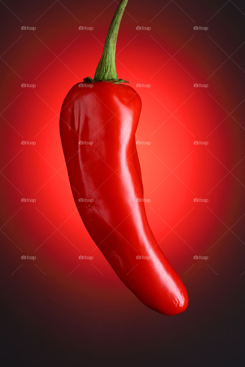 red hot chilli on red background