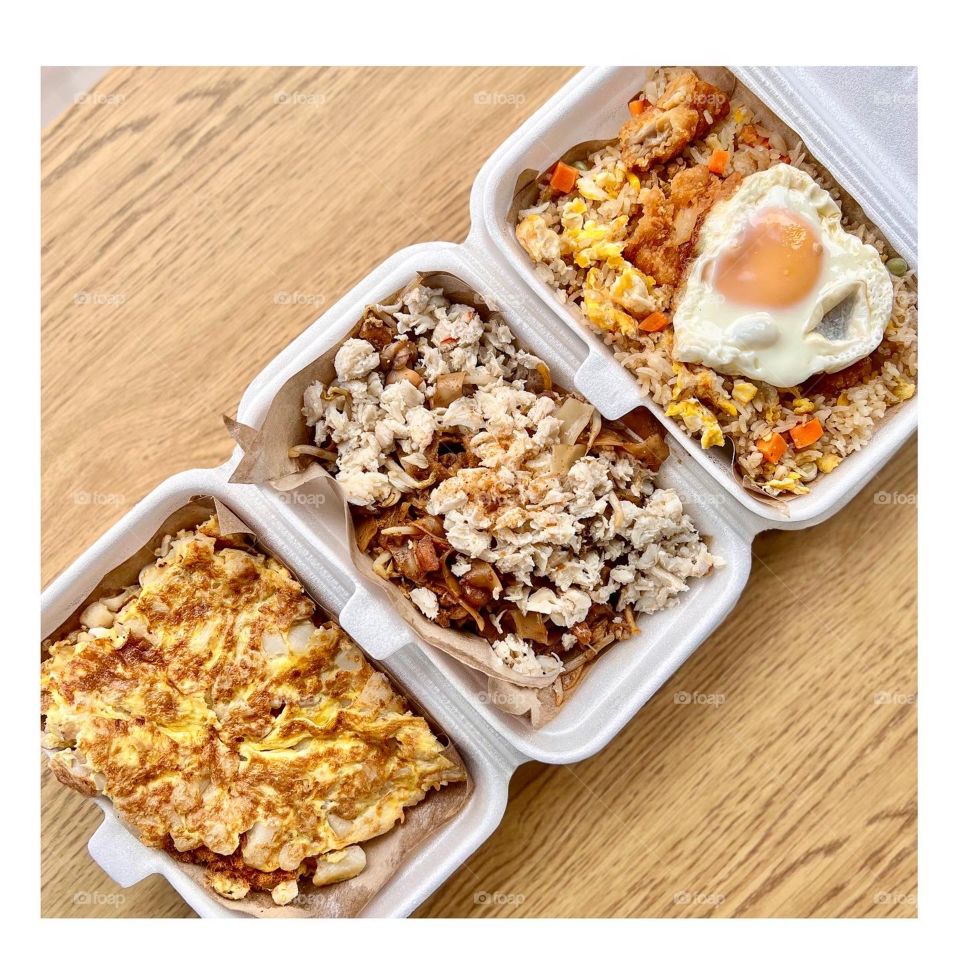 Local hawker asian dishes in cheesy floss carrot cake, crab meat char kway teow and fried rice with chicken and egg