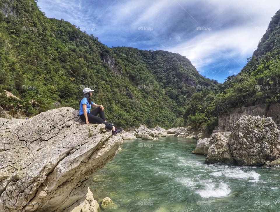 Woman relaxing on the riverside with Mountain View