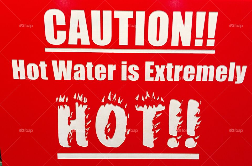 Public restroom sign warning. "caution water is extremely hot"