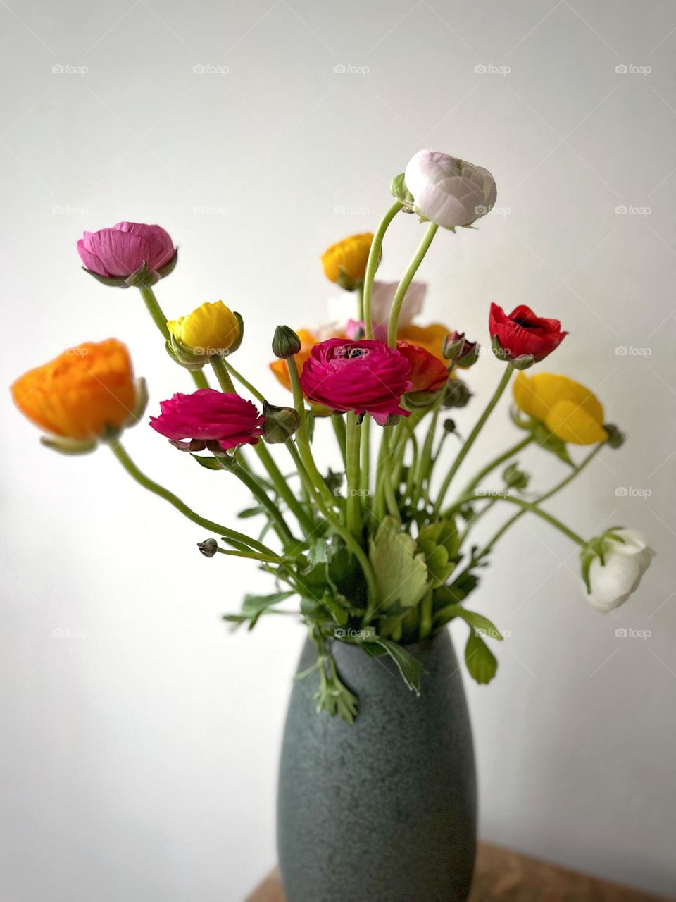 ranunculus in a green vase